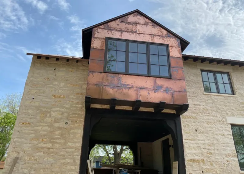Copper metal panel facade on a stone building for Skylight Installation in Maumee